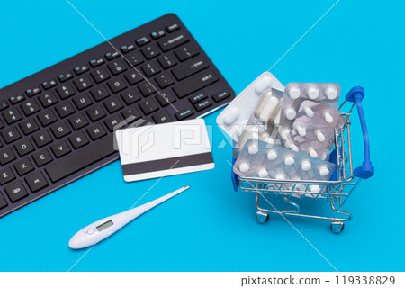 Ordering Medicines. Pills and Capsules in a Shopping Cart on Blue Background 119338829