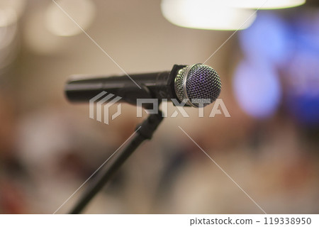 Microphone over the Abstract blurred photo of conference hall or seminar room background 119338950