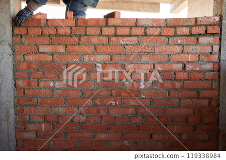 professional construction worker laying bricks and building barbecue in industrial site. Detail of hand adjusting bricks professional construction worker laying bricks and building barbecue in industrial site. Detail of hand adjusting bricks 119338984