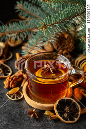 Tea with spices and dry fruits on a kitchen table. 119339105