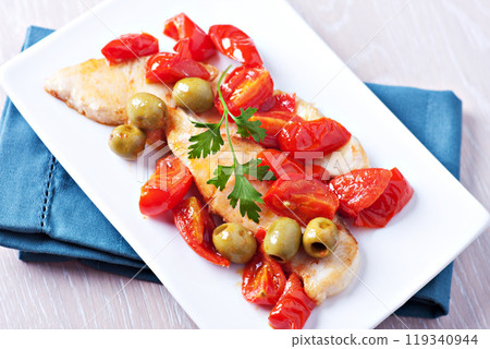 Fillet of halibut with tomatoes and olives 119340944