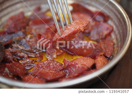 a dish of turkish breakfast sausage in a pan on a wooden table a dish of turkish breakfast sausage in a pan on a wooden table 119341057