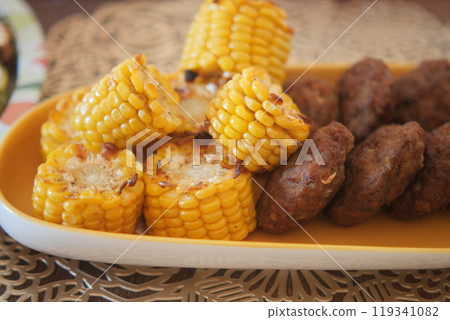 Try our Grilled Corn and Meatballs Platter, a delicious homemade meal to delight your taste buds 119341082