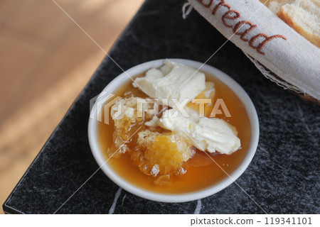 butter cream and honey in a bowl on table . butter cream and honey in a bowl on table . 119341101