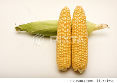 Three ears of corn on a white background. A printed cob. Ripe corn. Three ears of corn on a white background. A printed cob. Ripe corn. 119341690