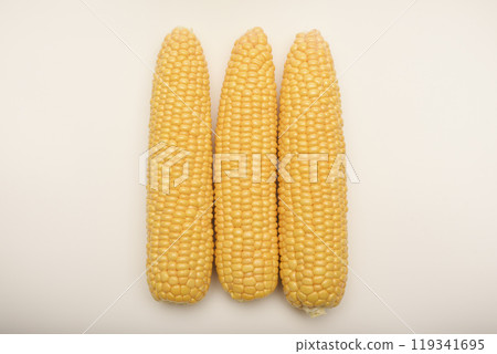 Three peeled ears of corn on a white background. A printed cob. Ripe delicious corn. Three peeled ears of corn on a white background. A printed cob. Ripe delicious corn. 119341695