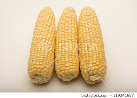 Three peeled ears of corn on a white background. A printed cob. Ripe delicious corn. Three peeled ears of corn on a white background. A printed cob. Ripe delicious corn. 119341697