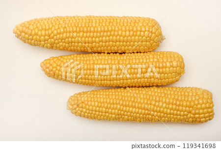 Three peeled ears of corn on a white background. A printed cob. Ripe delicious corn. Three peeled ears of corn on a white background. A printed cob. Ripe delicious corn. 119341698