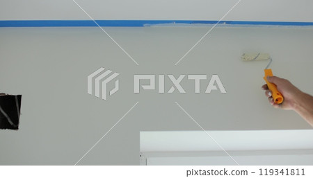 Man worker hand painting the wall inside the house and building. Builder, tools, apartment renovation. Man worker hand painting the wall inside the house and building. Builder, tools, apartment renovation. 119341811
