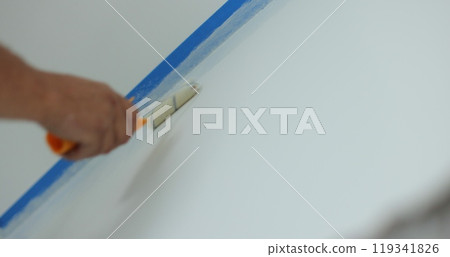 Man worker hand painting the wall inside the house and building. Builder, tools, apartment renovation. Man worker hand painting the wall inside the house and building. Builder, tools, apartment renovation. 119341826