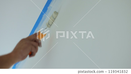 Man worker hand painting the wall inside the house and building. Builder, tools, apartment renovation. 119341832