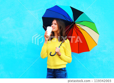 Happy pretty smiling woman with coffee cup and colorful umbrella in autumn day Happy pretty smiling woman with coffee cup and colorful umbrella in autumn day 119342003
