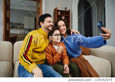 Family enjoys quality time together while taking a selfie at home Family enjoys quality time together while taking a selfie at home 119342074