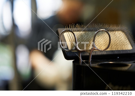 Close-up of hairdressing tools during a salon service in the afternoon Close-up of hairdressing tools during a salon service in the afternoon 119342210