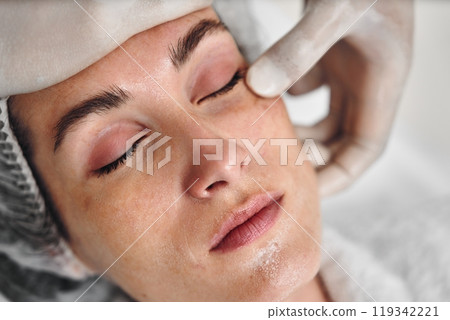 Aesthetic treatment session for a woman at a beauty clinic during daytime 119342221