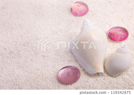 Border with seashells and red glass pebbles on white sand. 119342875