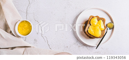 Delicious toasts with honey butter on a plate on the table top view web banner Delicious toasts with honey butter on a plate on the table top view web banner 119343056