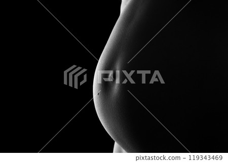 Belly of a very pregnant woman 119343469