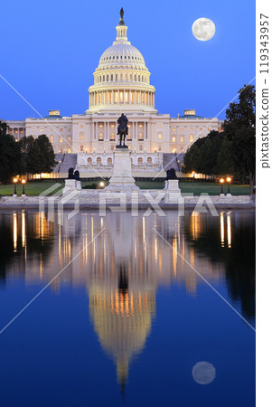 US Capitol illuminated at dusk in Washington DC with nice reflections into the water, USA 119343957