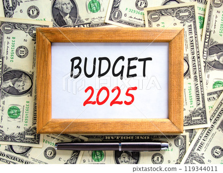 Planning budget 2025 new year symbol. Concept words Budget 2025 on beautiful wooden picture frame. Beautiful background from dollar bills. Black pen. Business budget 2025 new year concept. Copy space. 119344011