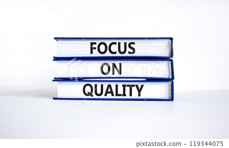 Focus on quality symbol. Concept words Focus on quality on books on beautiful white table white background. Business, focus on quality concept. Copy space. Focus on quality symbol. Concept words Focus on quality on books on beautiful white table white background. Business, focus on quality concept. Copy space. 119344075