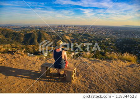 Tourist overlooking the Los Angeles skyline from Mount Lee at sunset Tourist overlooking the Los Angeles skyline from Mount Lee at sunset 119344528