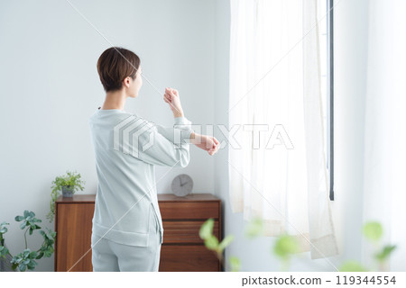 Woman stretching in pajamas in the morning 119344554