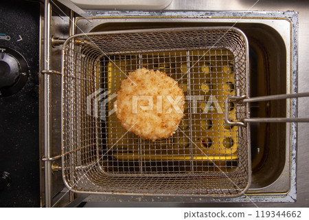 Fried cutlet in fryer basket Fried cutlet in fryer basket 119344662