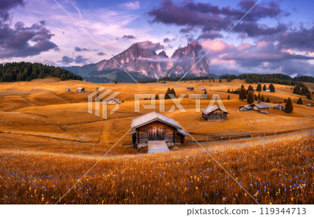 Wooden houses on orange meadows in mountain valley in autumn Wooden houses on orange meadows in mountain valley in autumn 119344713