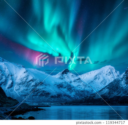 Aurora over the snowy mountains, frozen sea, reflection in water 119344717