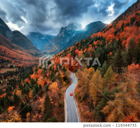 Aerial view of winding mountain road in forest at sunset. Autumn Aerial view of winding mountain road in forest at sunset. Autumn 119344735