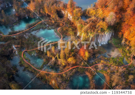 Aerial view of waterfall in red autumn forest at sunrise Aerial view of waterfall in red autumn forest at sunrise 119344738