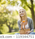 Beautiful American woman happily having lunch in the park 119344751