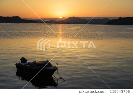 The sun rising over a fishing port in Setouchi and the Sun Road stretching out to sea The sun rising over a fishing port in Setouchi and the Sun Road stretching out to sea 119345706