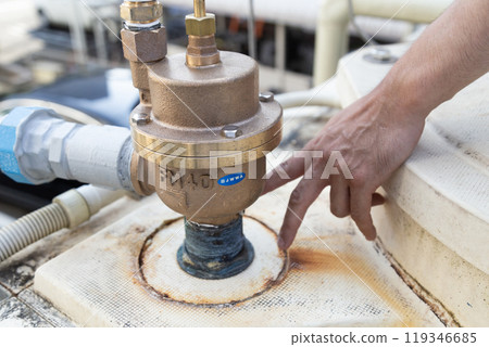 Worker performing inspection work Worker performing inspection work 119346685