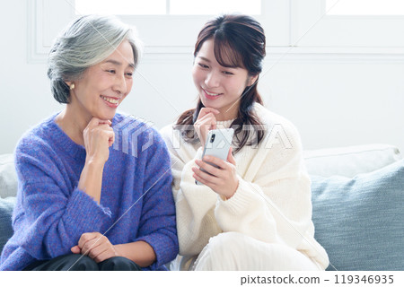 Grandson teaching grandma how to use a smartphone 119346935