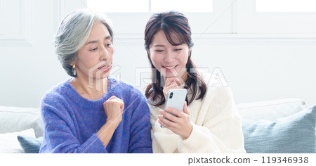 Grandson teaching grandma how to use a smartphone Grandson teaching grandma how to use a smartphone 119346938