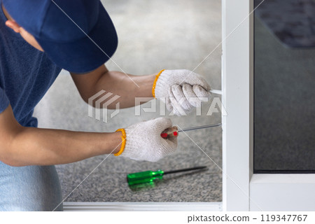 Worker replace aluminium swing door lock. 119347767