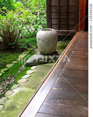 Autumn scenery of an old house with a corridor and a stone basin Autumn scenery of an old house with a corridor and a stone basin 119348126