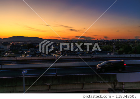 Evening view of Shijo Oji in Nara City, a view from the rooftop of the Minara Parking Lot, a commercial facility, a golden sunset and a cobalt blue sky Evening view of Shijo Oji in Nara City, a view from the rooftop of the Minara Parking Lot, a commercial facility, a golden sunset and a cobalt blue sky 119348505