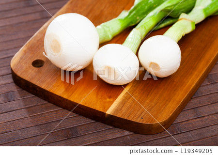 Spring onion on wooden table, food preparation 119349205