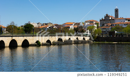 Urban landscape of city of Mirandela in the north of Portugal. Panoramic view of the banks of the river Tua with traditional Roman bridge 119349251