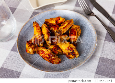 Fried chicken wings with golden crust served with on plate Fried chicken wings with golden crust served with on plate 119349261