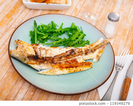 Fresh baked fish sea bass with arugula 119349279