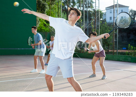 Sports active man during friendly doubles couple match. Two men playing frontenis together outdoor 119349283