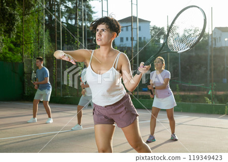 Woman playing frontenis on outdoor pelota court Woman playing frontenis on outdoor pelota court 119349423