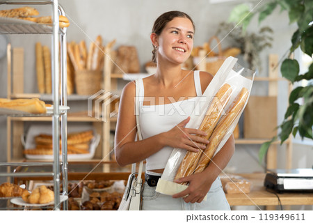 Young woman with baguette in bakery 119349611