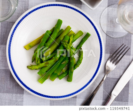 Boiled shoots of green asparagus are stacked in plate Boiled shoots of green asparagus are stacked in plate 119349741