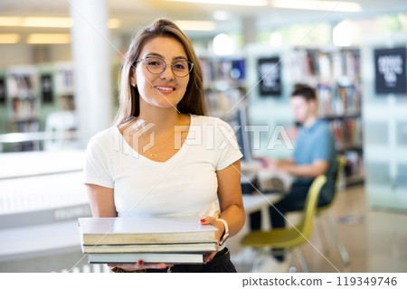Intelligent Latina girl hold academic books Intelligent Latina girl hold academic books 119349746