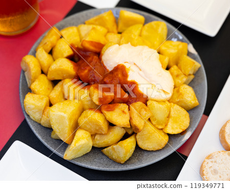 Baked potatoes with creamy sauce aioli and tomato salsa Baked potatoes with creamy sauce aioli and tomato salsa 119349771